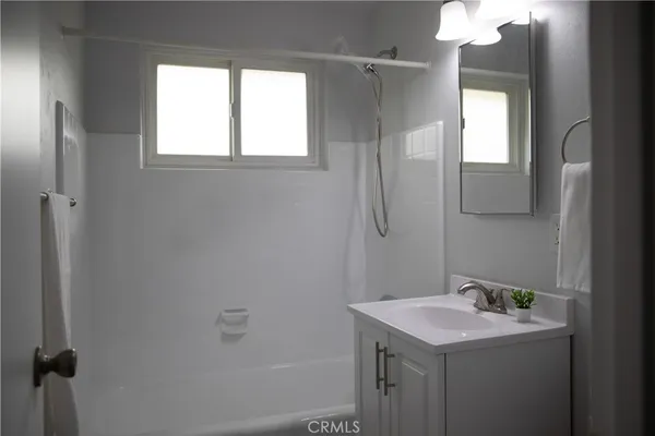 a bathroom with a sink a mirror and a window