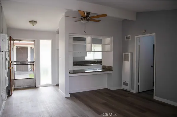 a kitchen with a refrigerator and a stove top oven