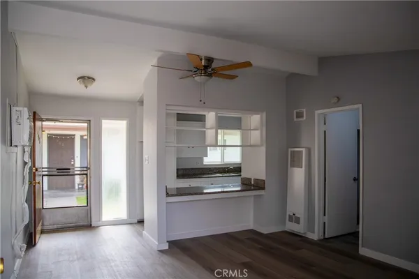 a kitchen with a refrigerator and a stove top oven