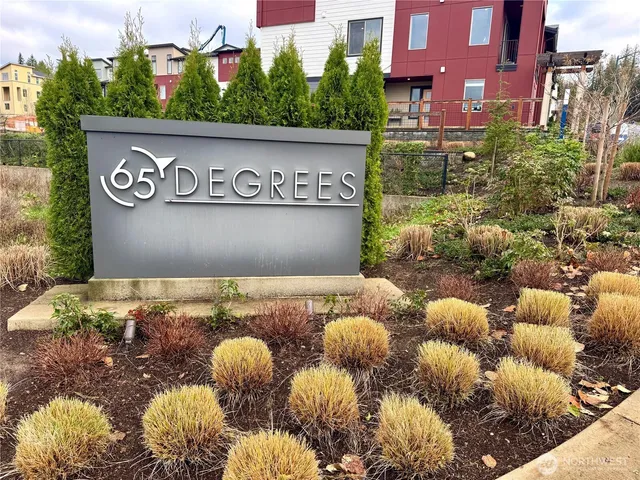 a view of a house with a yard and a car parked beside it