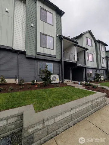 a kitchen with granite countertop a stove and a wooden floor