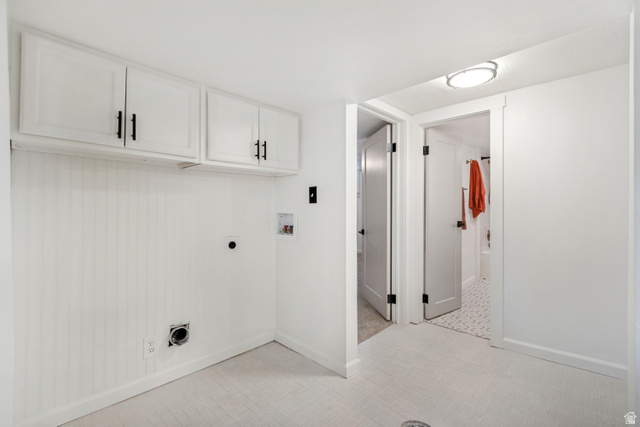 4883 South Center Street Murray, UT 84107 - Photo 26 of 32 Dedicated utility area featuring white cabinetry with black hardware, beadboard wall paneling, and light-toned flooring