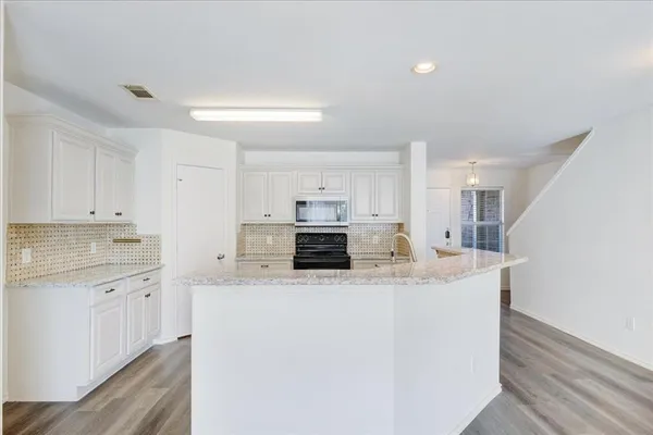 a large kitchen with stainless steel appliances