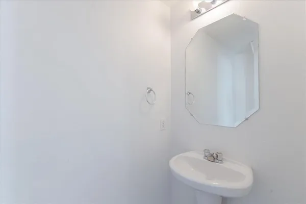 a bathroom with a sink and mirror