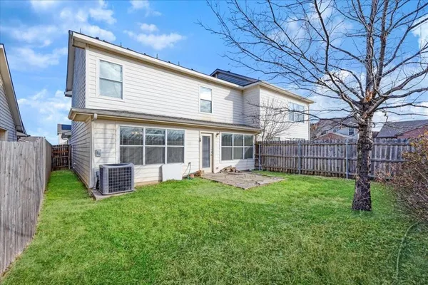 a view of a house with a yard and sitting area