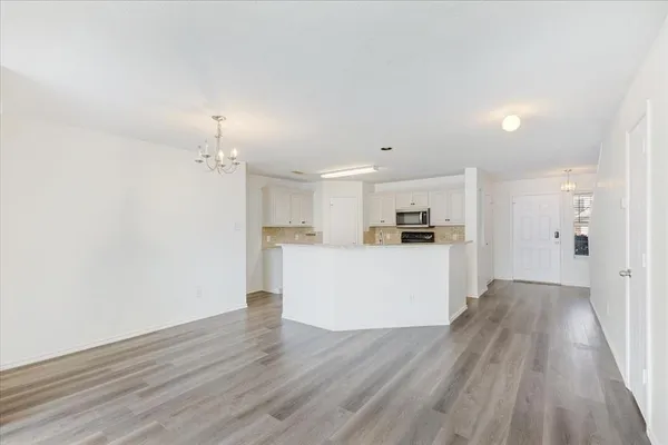 a view of kitchen with wooden floor and window