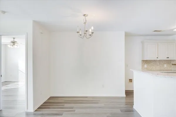 a view of a kitchen with wooden floor and a sink