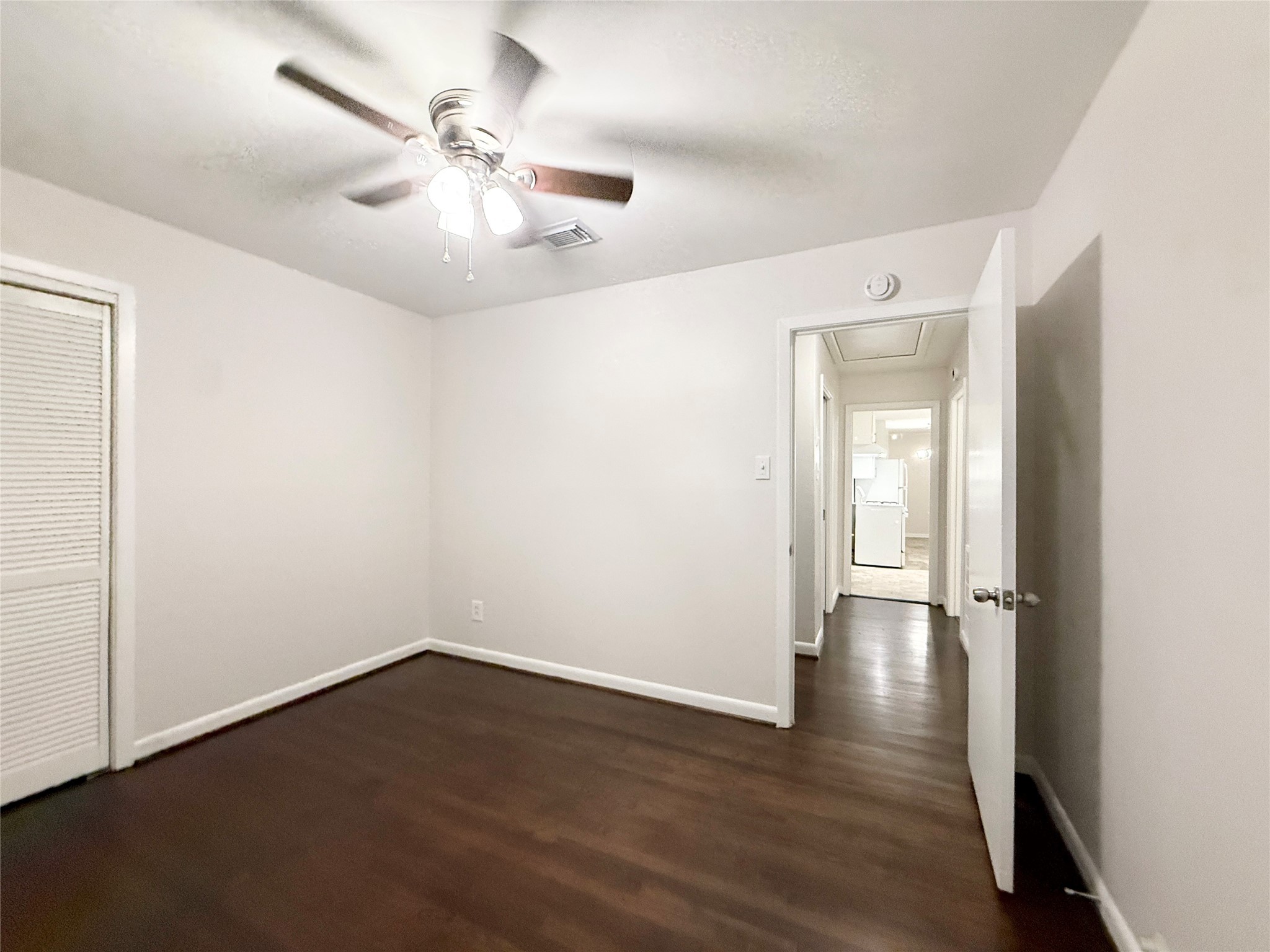 913 Wimberly Street Angleton, TX 77515 - Photo 16 of 24 an empty room with wooden floor and fan
