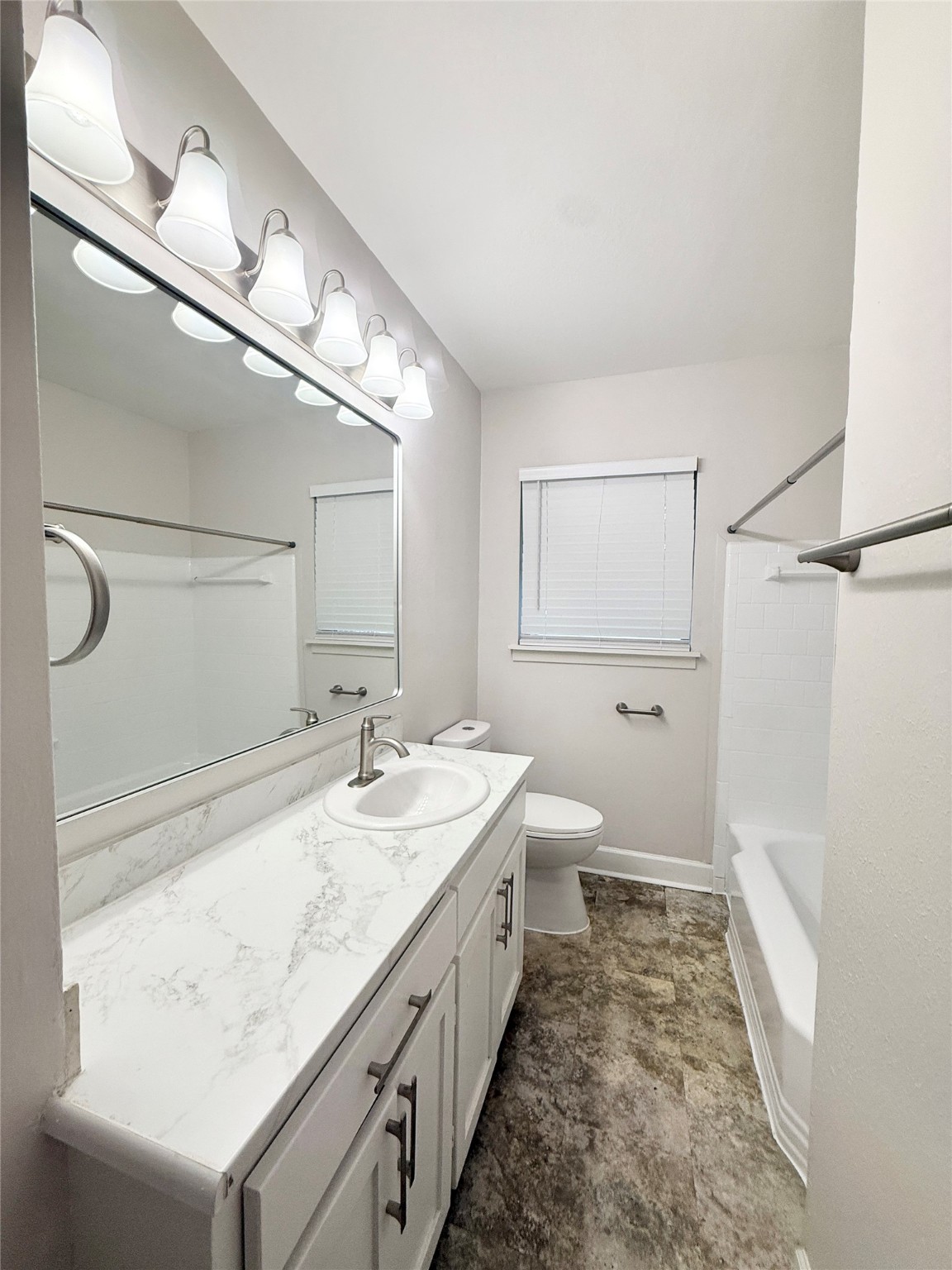 913 Wimberly Street Angleton, TX 77515 - Photo 17 of 24 a spacious bathroom with a double vanity sink and a mirror