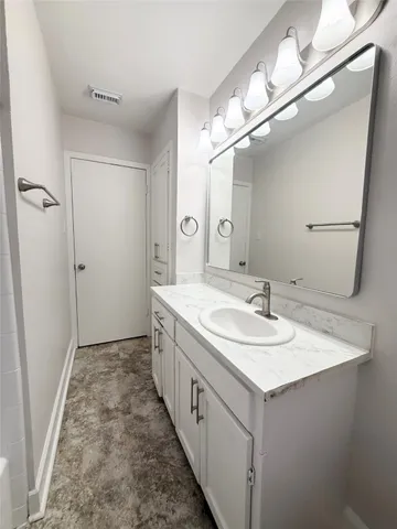 a bathroom with a sink a mirror and a shower