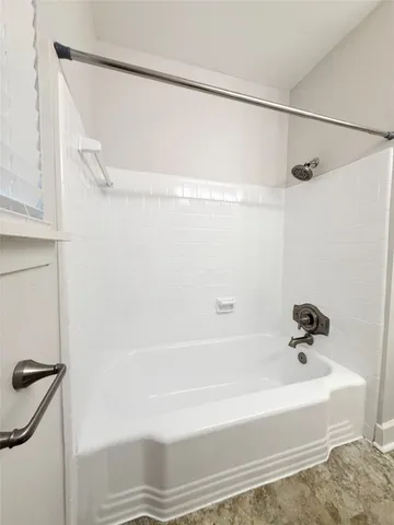 a bathroom with a shower and a bath tub