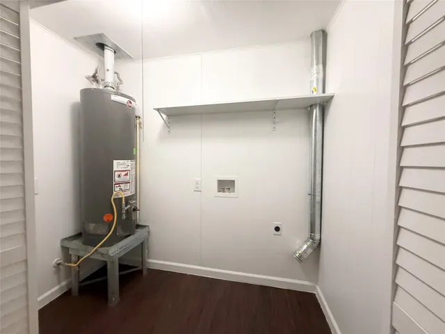 a room with a walk in closet and wooden floor