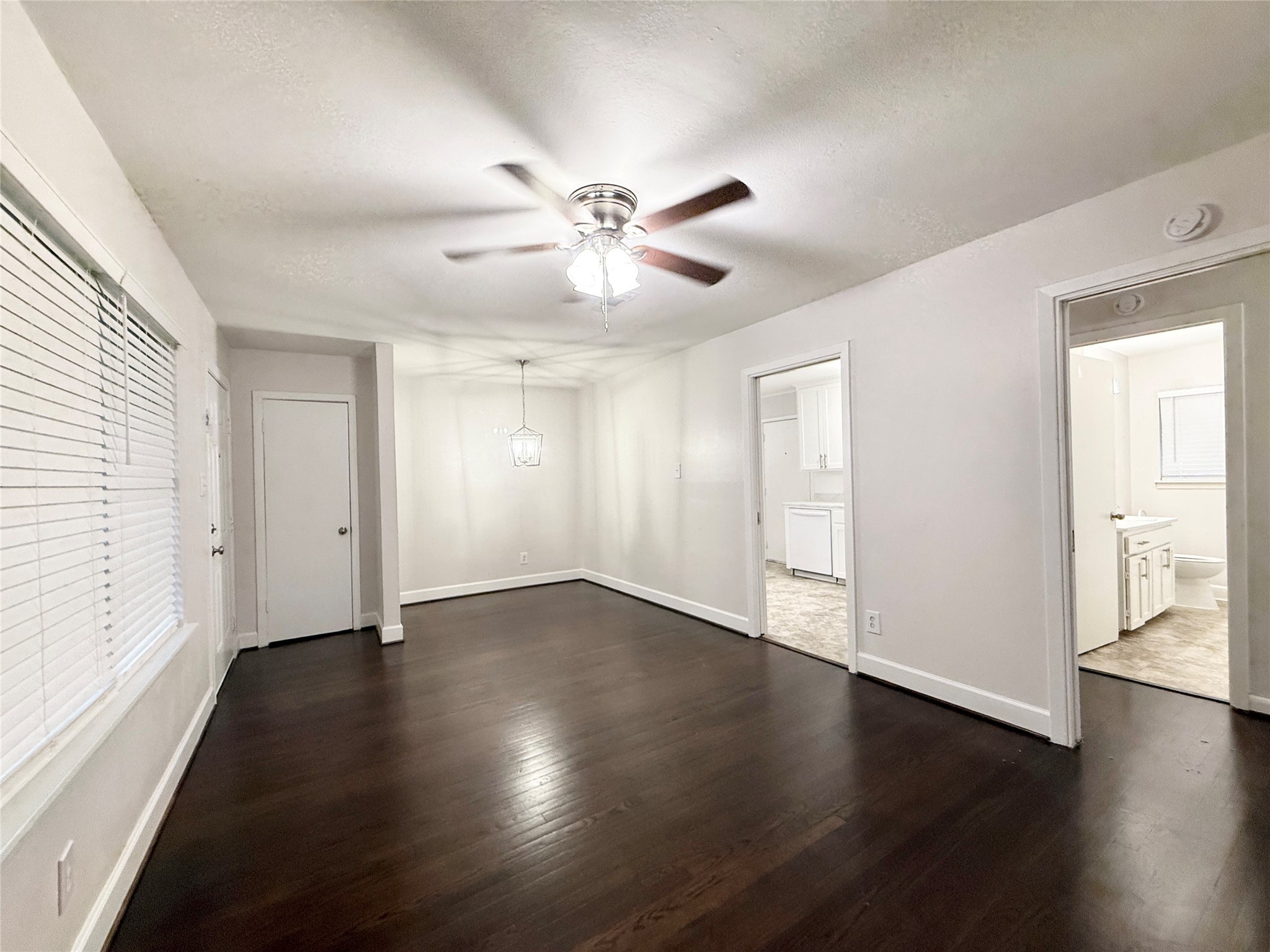 913 Wimberly Street Angleton, TX 77515 - Photo 4 of 24 a view of an empty room with window and wooden floor