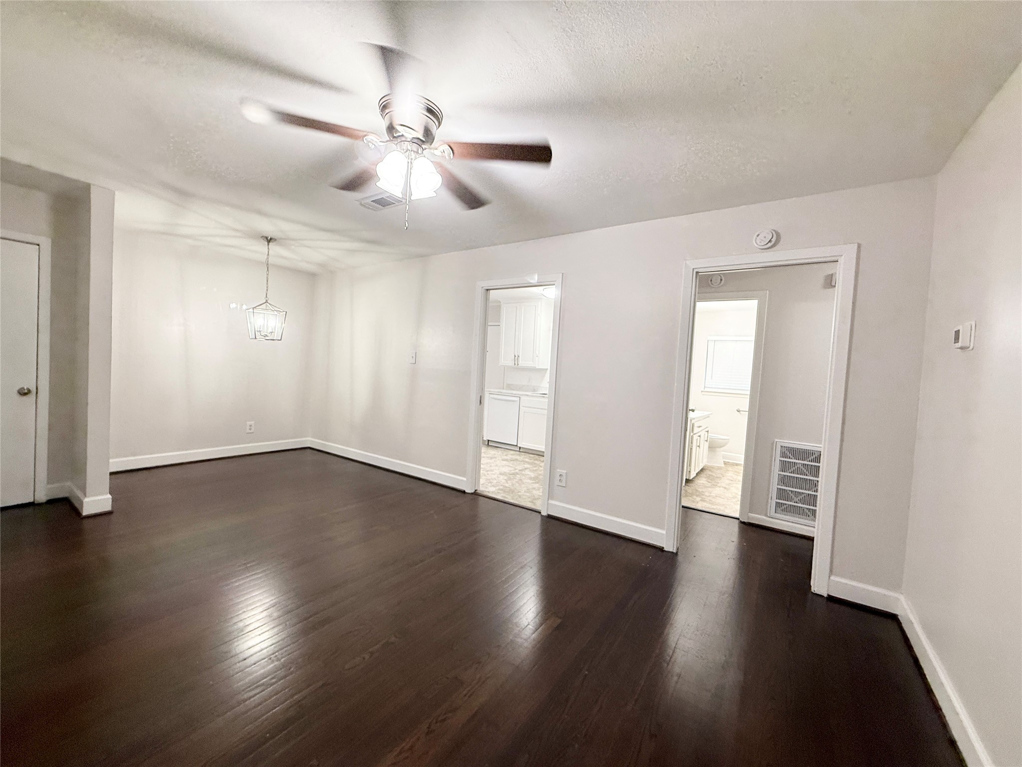 913 Wimberly Street Angleton, TX 77515 - Photo 5 of 24 a view of an empty room with wooden floor and fan