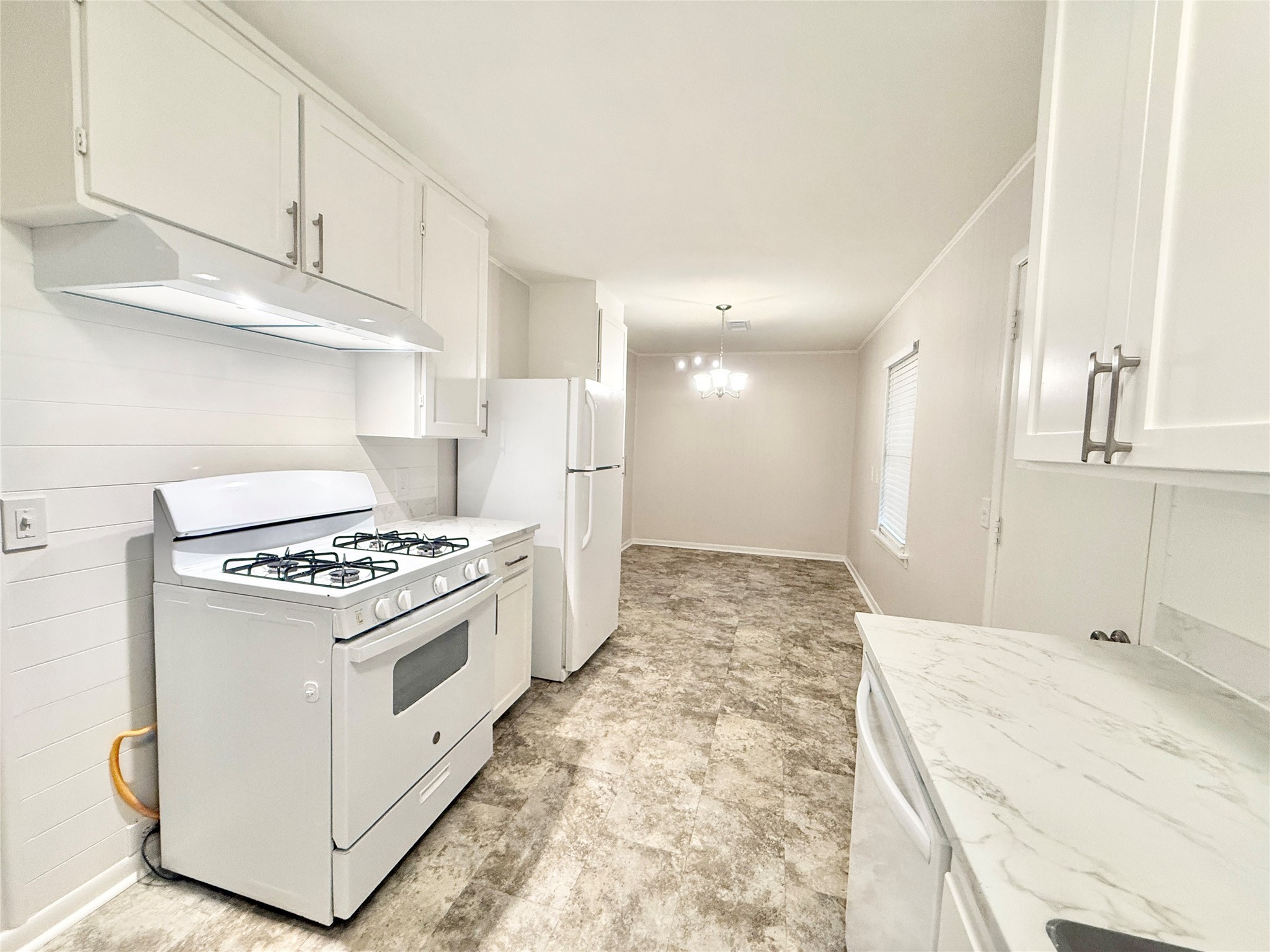 913 Wimberly Street Angleton, TX 77515 - Photo 8 of 24 a kitchen with stainless steel appliances granite countertop a stove and a refrigerator