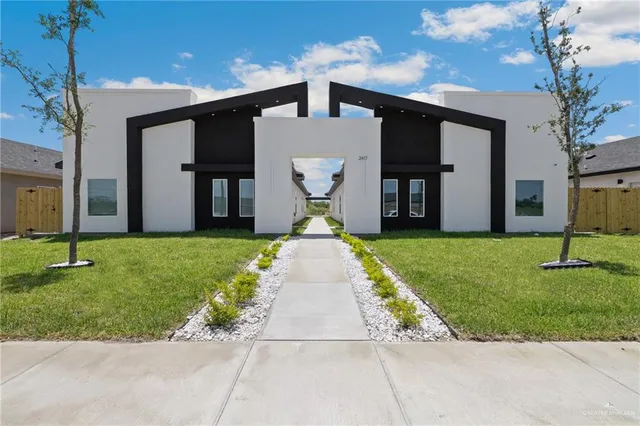 a front view of a house with a garden
