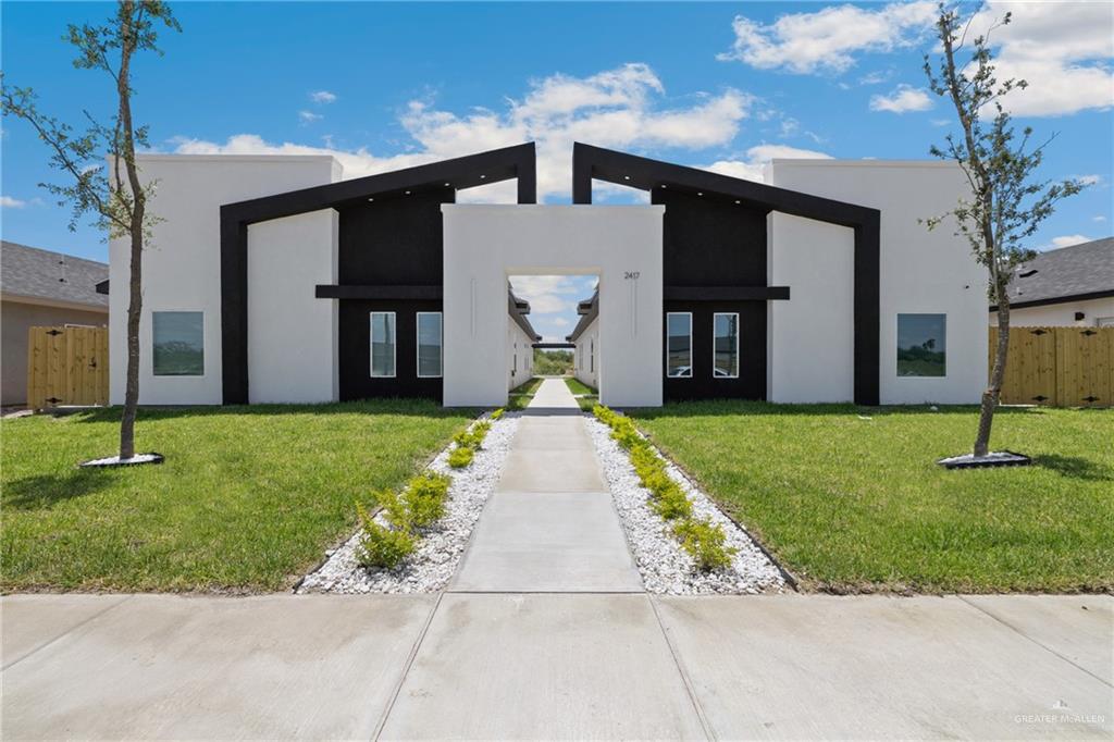 a front view of a house with a garden