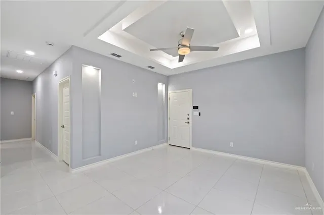 an empty room with fan and entrance