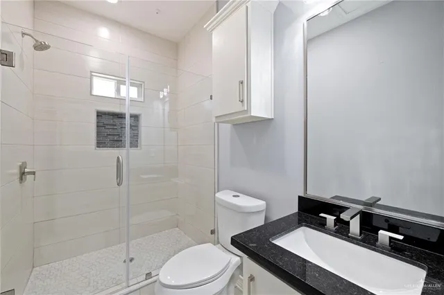 a bathroom with a sink toilet and shower