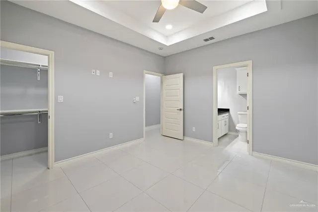 a view of an empty room and a bathroom