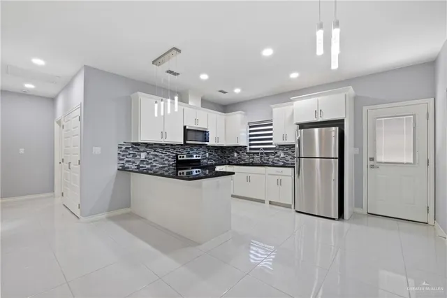 a kitchen with refrigerator and cabinets