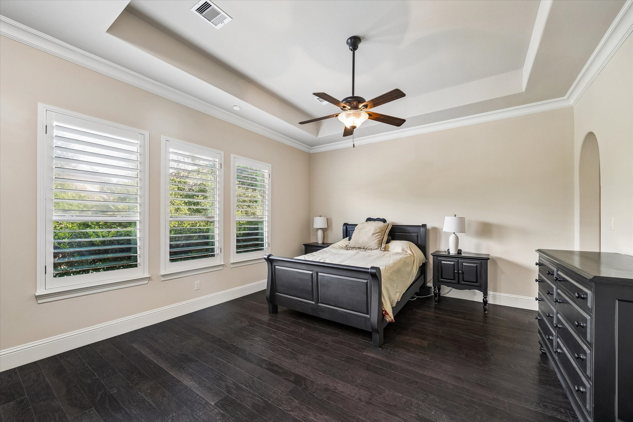 3 Tiburon Court Spring, TX 77389 - Photo 15 of 34 At the end of a busy day, this is where the world slows down. The spacious first-floor primary suite feels like a private retreat, filled with soft natural light streaming through oversized windows overlooking the backyard. The tray ceiling adds a touch of elegance, while the generous layout offers plenty of room for a quiet reading corner or simply a place to exhale.
One of the home's most thoughtful features is the private door leading directly to the outdoor patio.
