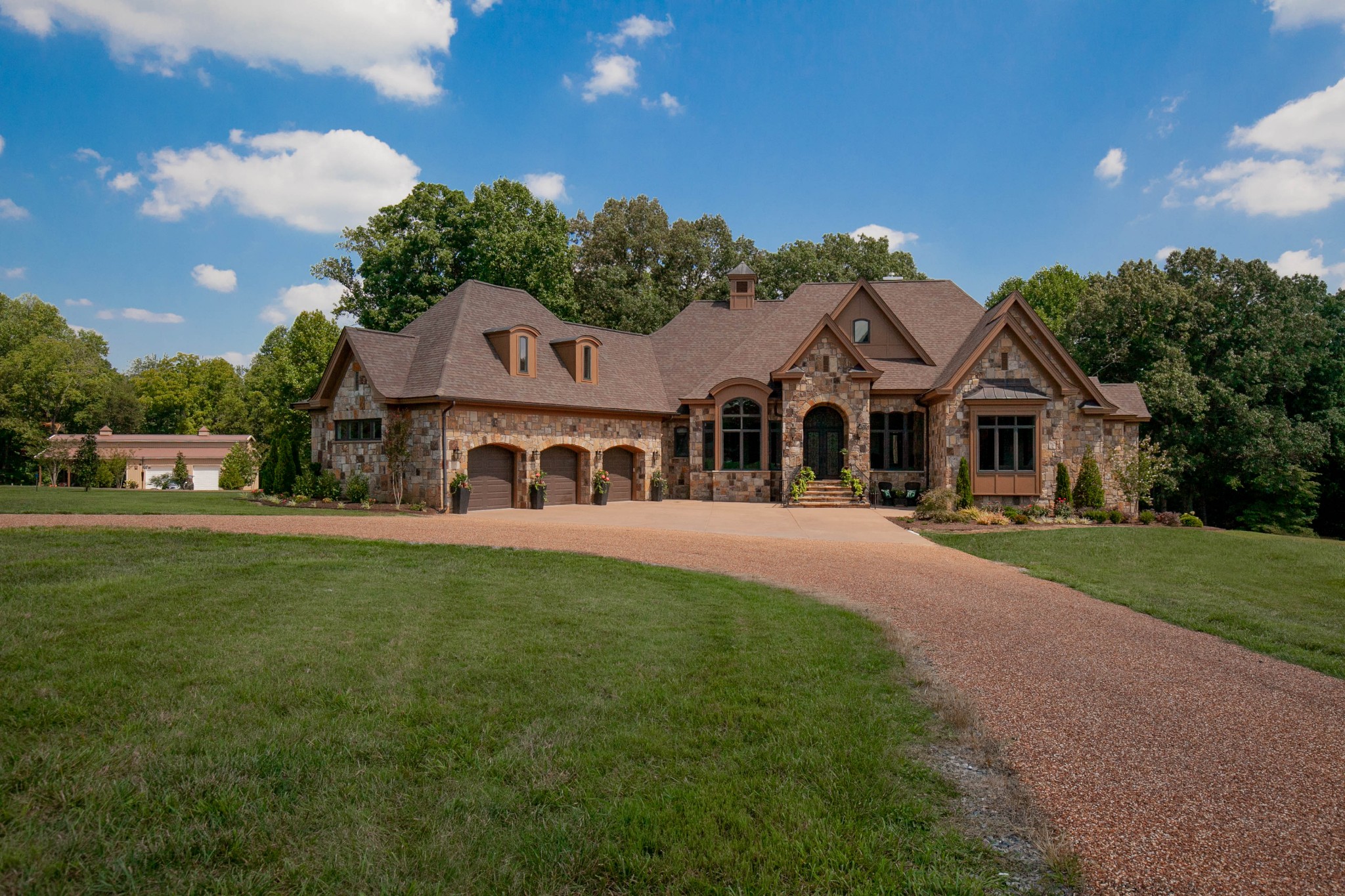 a front view of a house with a garden