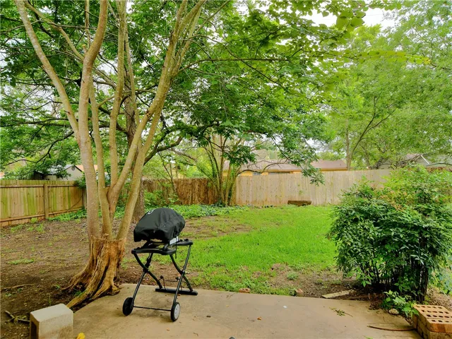 a view of a chairs and table in the garden