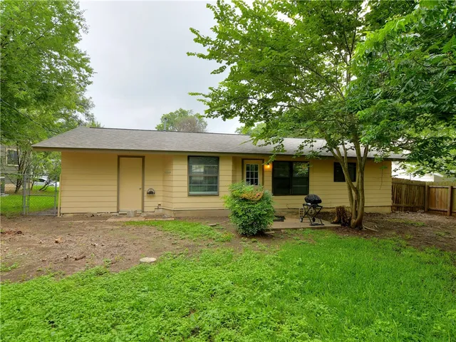 a view of a house with a yard and sitting area