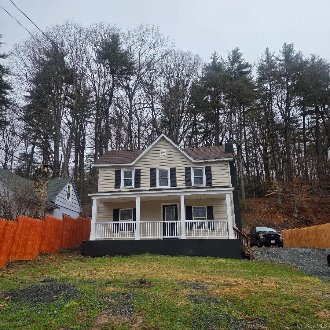 a front view of a house with a yard table and chairs