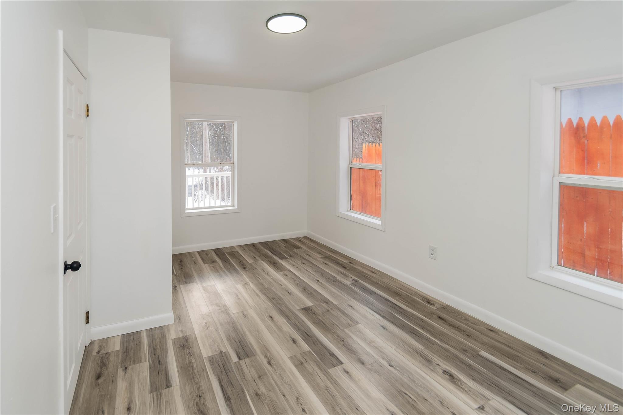 112 State Rte 55 Napanoch, NY 12458 - Photo 11 of 42 a view of empty room with wooden floor and fan