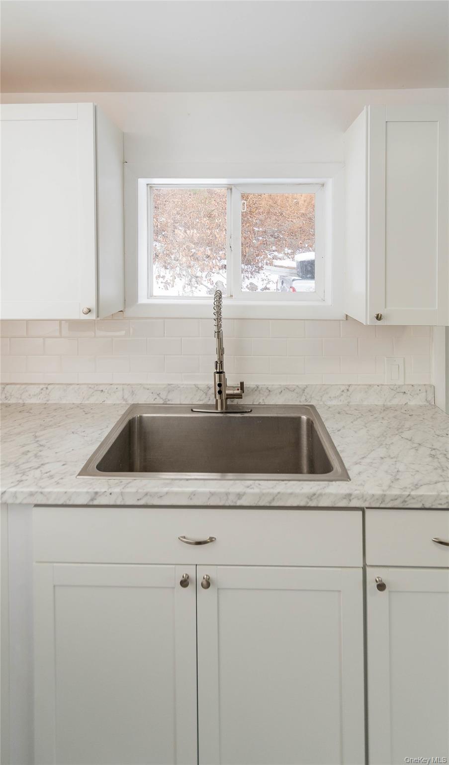 112 State Rte 55 Napanoch, NY 12458 - Photo 22 of 42 Kitchen with white cabinetry, backsplash, and light stone countertops