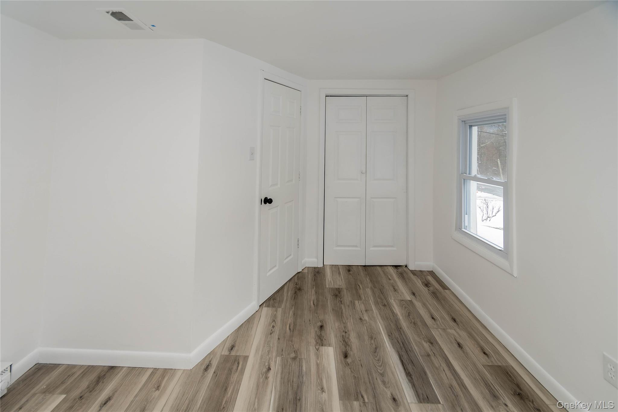 112 State Rte 55 Napanoch, NY 12458 - Photo 25 of 42 a view of an empty room with wooden floor and a window