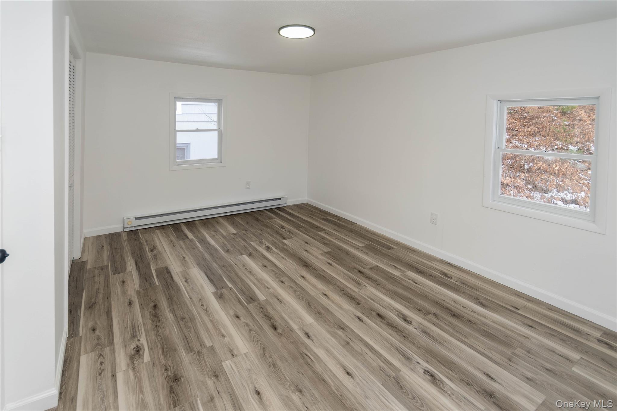 112 State Rte 55 Napanoch, NY 12458 - Photo 27 of 42 a view of an empty room with wooden floor and a window