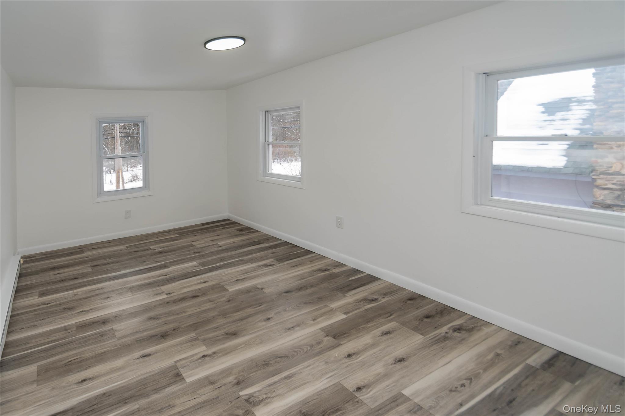 112 State Rte 55 Napanoch, NY 12458 - Photo 29 of 42 a view of empty room with wooden floor and fan