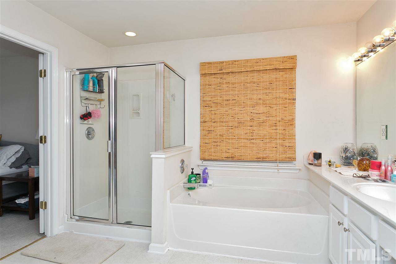 5410 Regatta Way Raleigh, NC 27613 - Photo 11 of 18 a bathroom with a bathtub and a shower