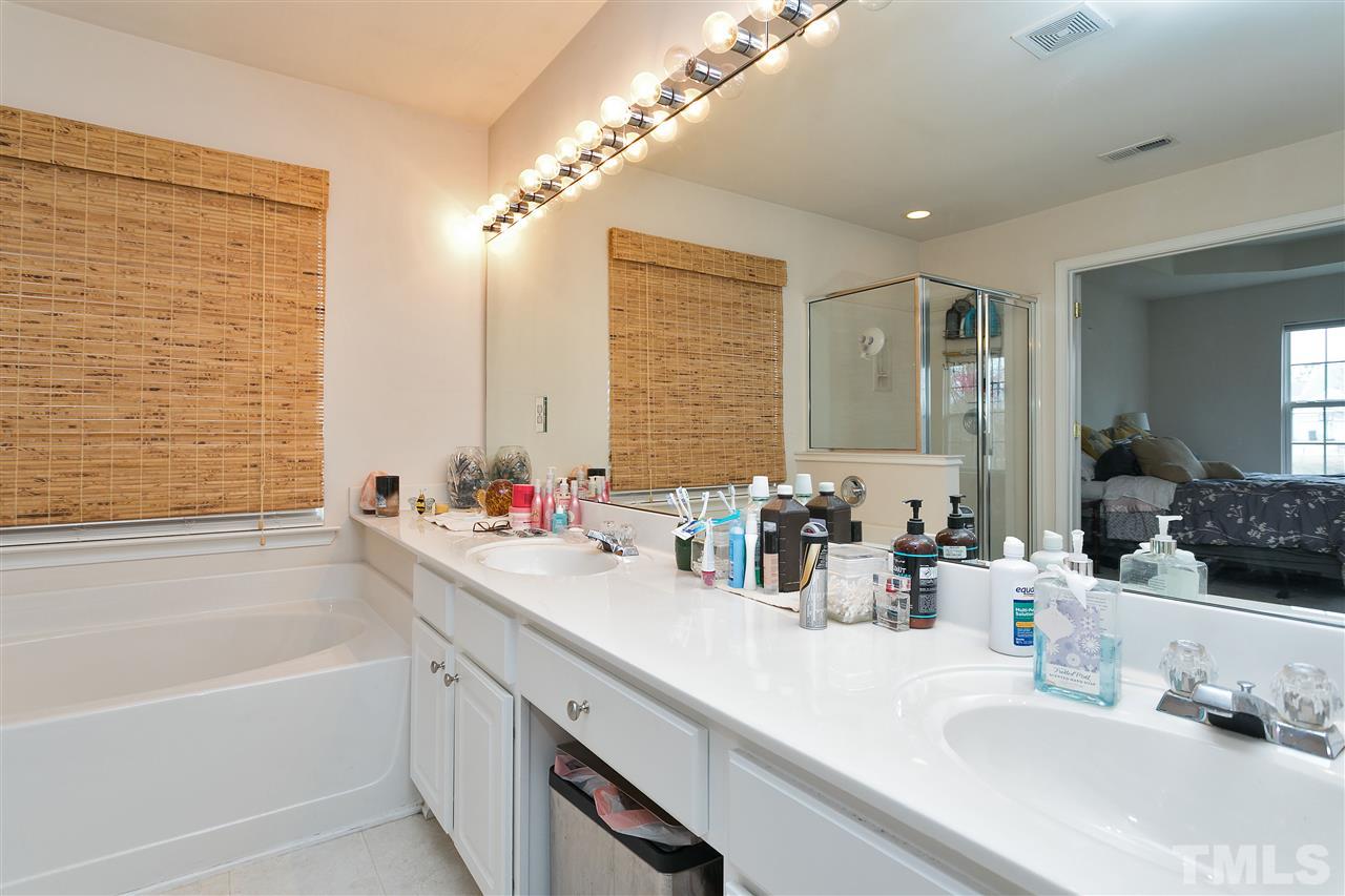 5410 Regatta Way Raleigh, NC 27613 - Photo 12 of 18 a bathroom with a tub sink and mirror