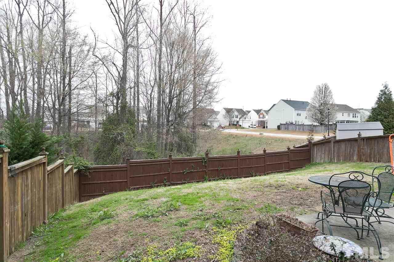 5410 Regatta Way Raleigh, NC 27613 - Photo 17 of 18 a view of a chairs and table in the back yard
