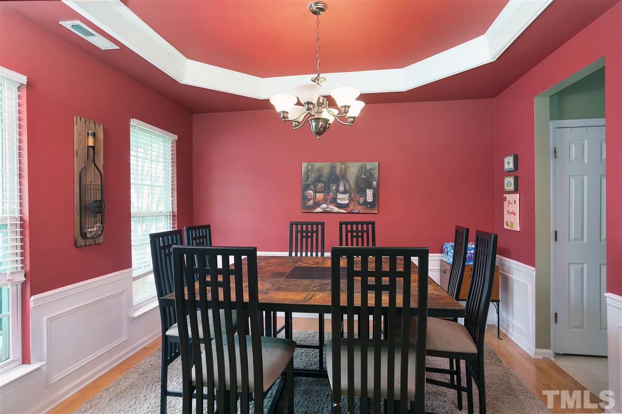 5410 Regatta Way Raleigh, NC 27613 - Photo 5 of 18 a view of a dining room with furniture a chandelier and wooden floor