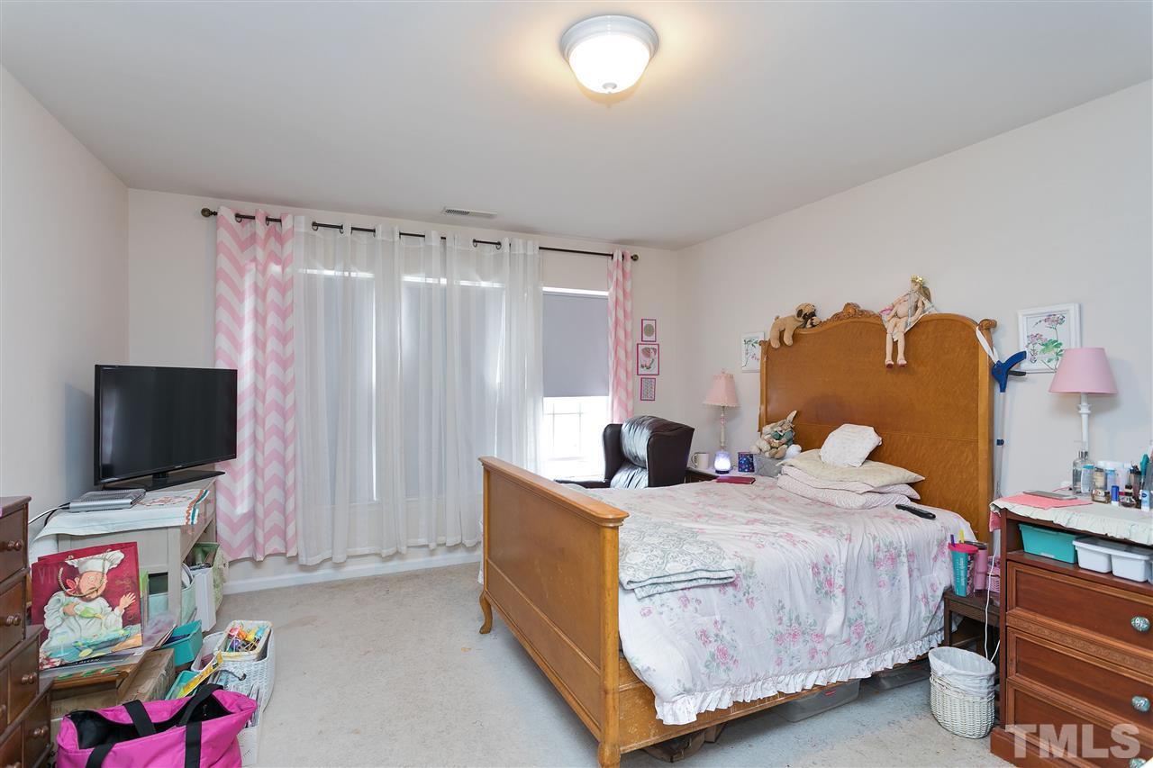 5410 Regatta Way Raleigh, NC 27613 - Photo 10 of 18 a bedroom with a bed and a flat screen tv