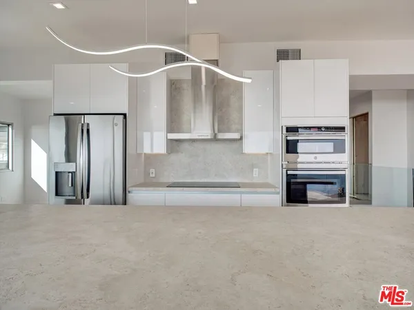 a bathroom with a tub sink mirror and shower