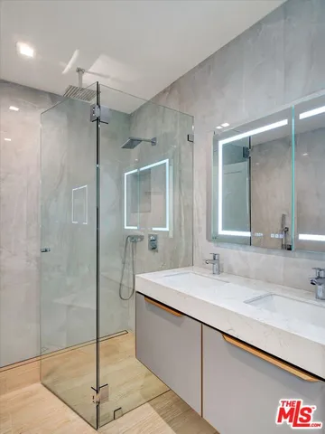a bathroom with a tub sink mirror and shower
