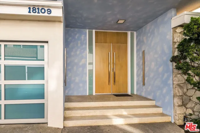 a view of a hallway with wooden floor and a potted plant