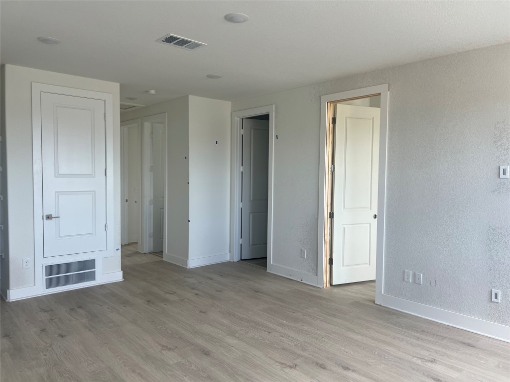 1507 Corsac Way Austin, TX 78758 - Photo 6 of 14 a view of an empty room with wooden floor