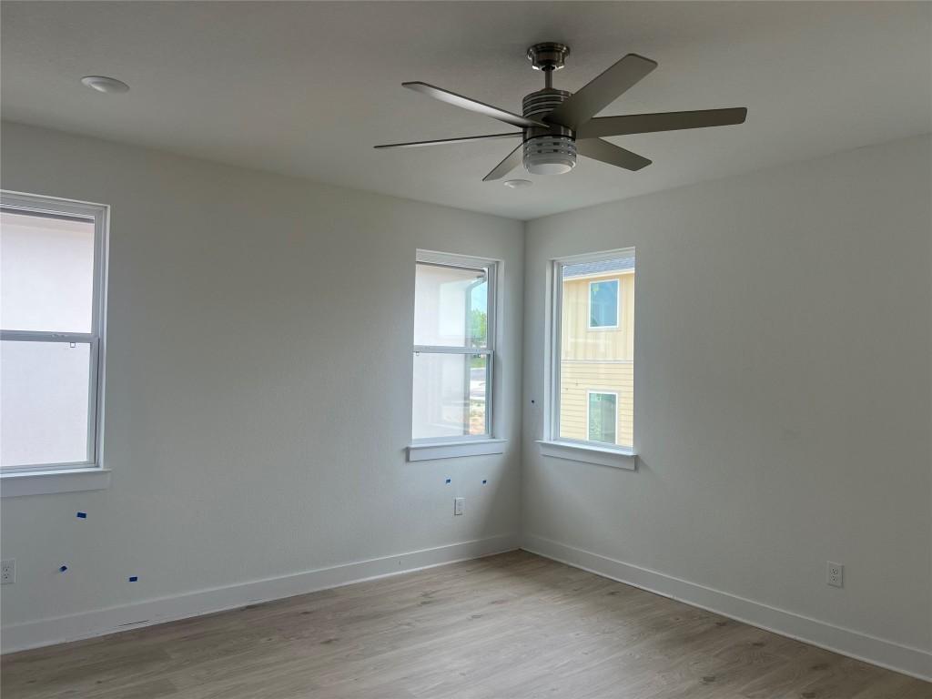 1507 Corsac Way Austin, TX 78758 - Photo 7 of 14 an empty room with a window and a fan