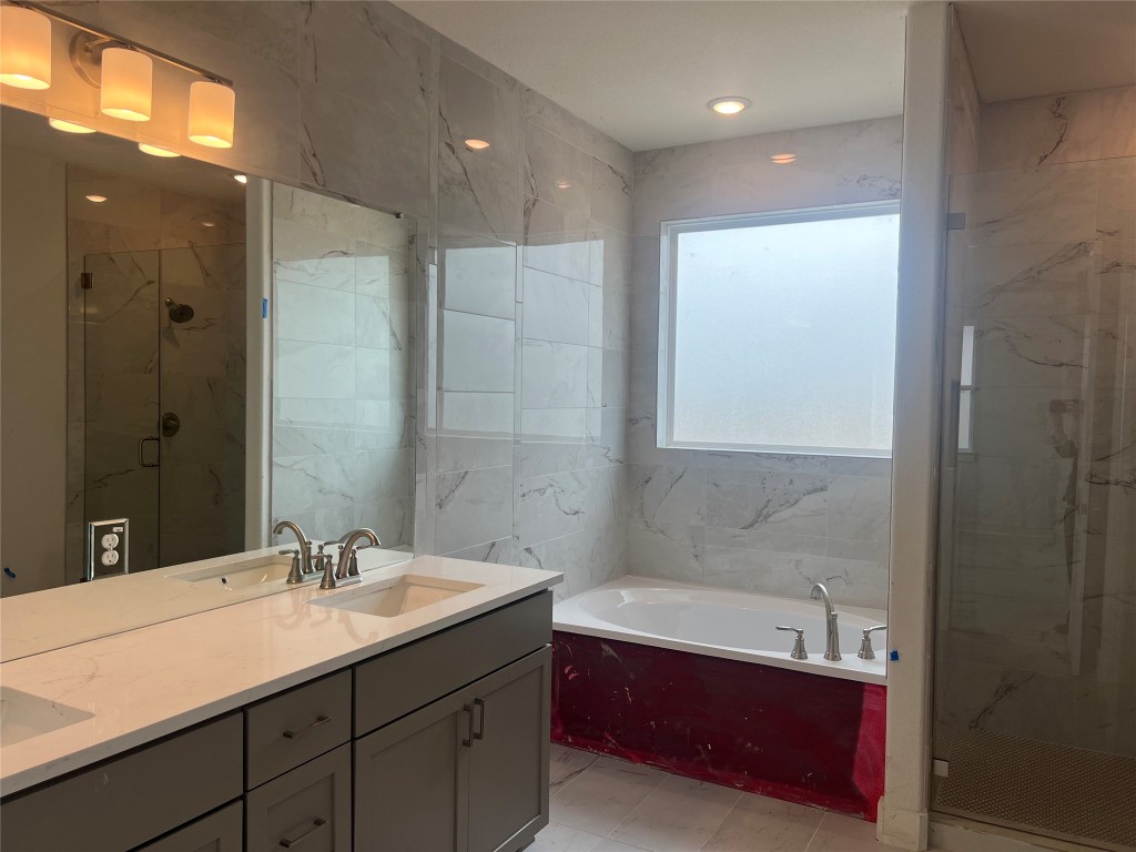 1507 Corsac Way Austin, TX 78758 - Photo 8 of 14 a bathroom with a tub sink shower and two mirror