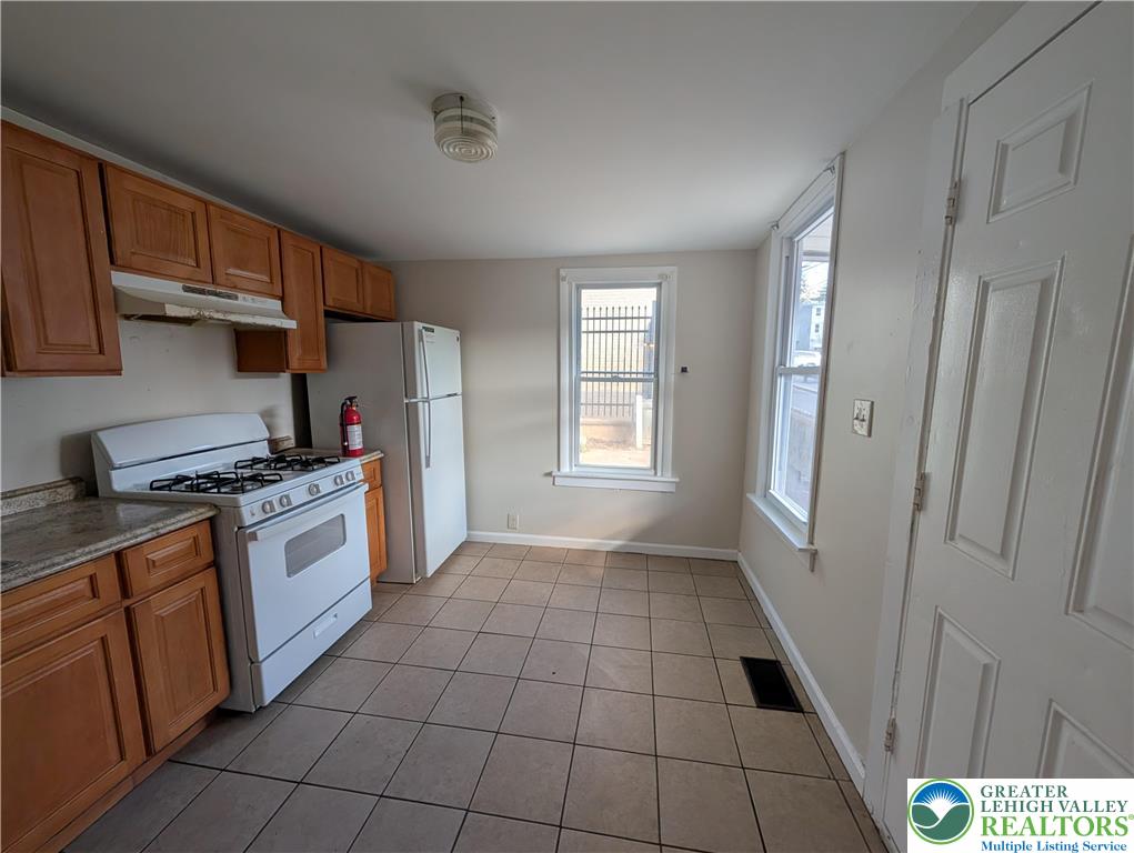 723 Chestnut Street Allentown, PA 18102 - Photo 11 of 25 a kitchen with stainless steel appliances a refrigerator and a stove top oven