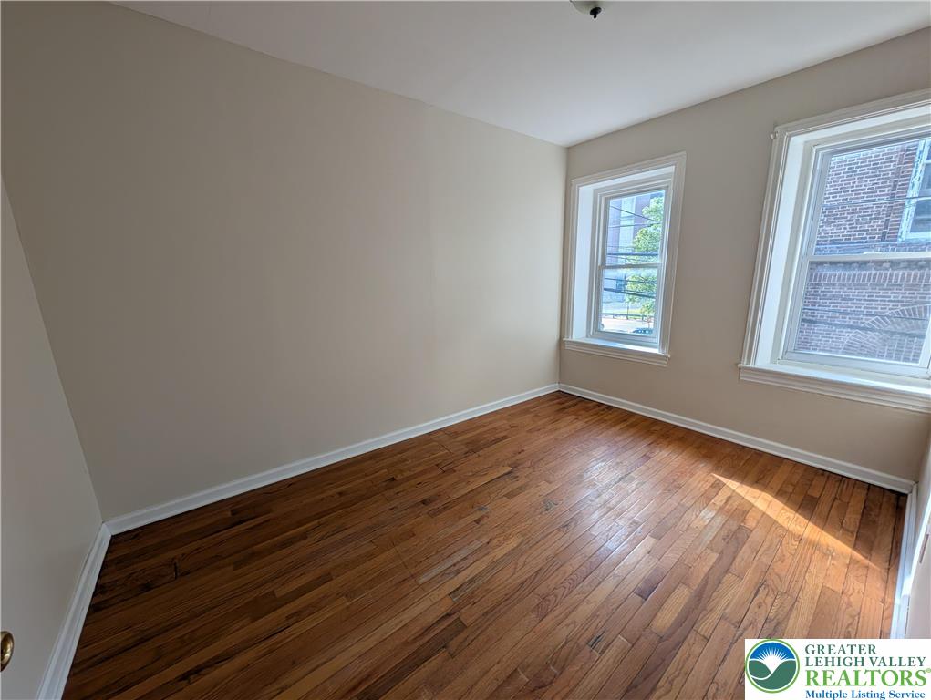 723 Chestnut Street Allentown, PA 18102 - Photo 17 of 25 a view of an empty room with wooden floor and a window