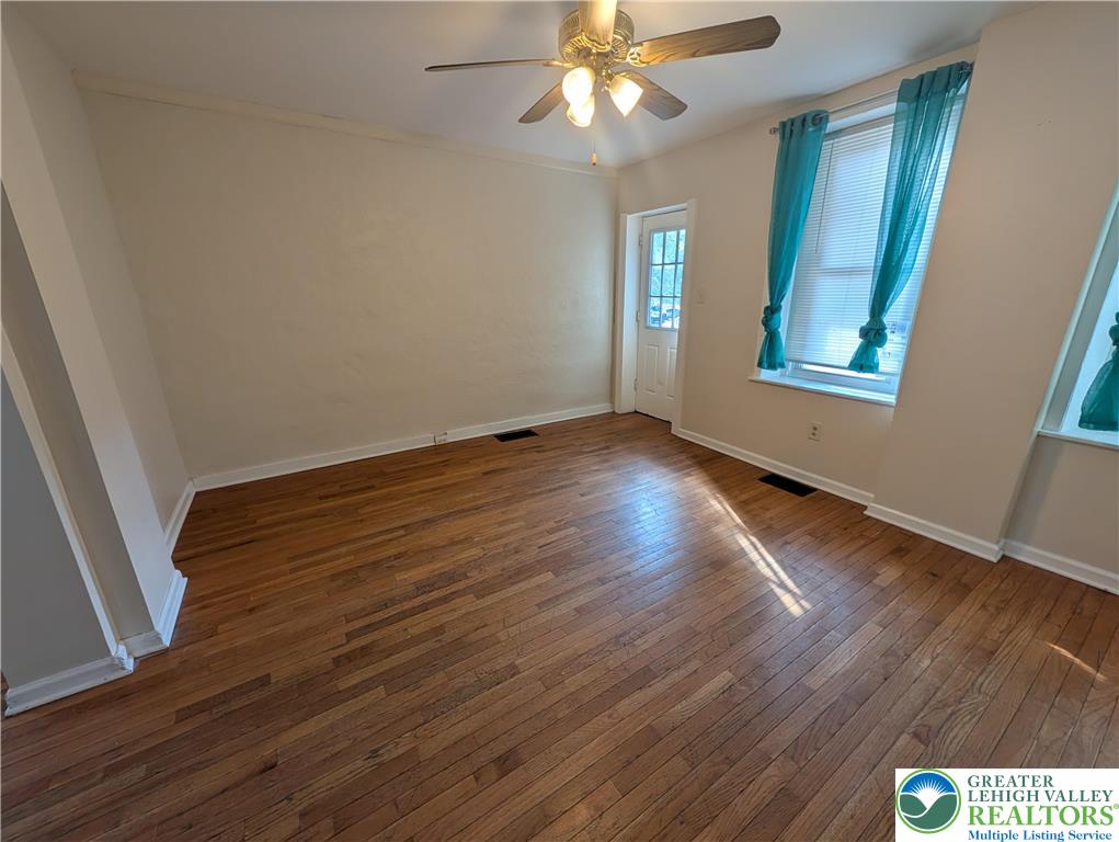 723 Chestnut Street Allentown, PA 18102 - Photo 2 of 25 a view of an empty room with wooden floor and a window