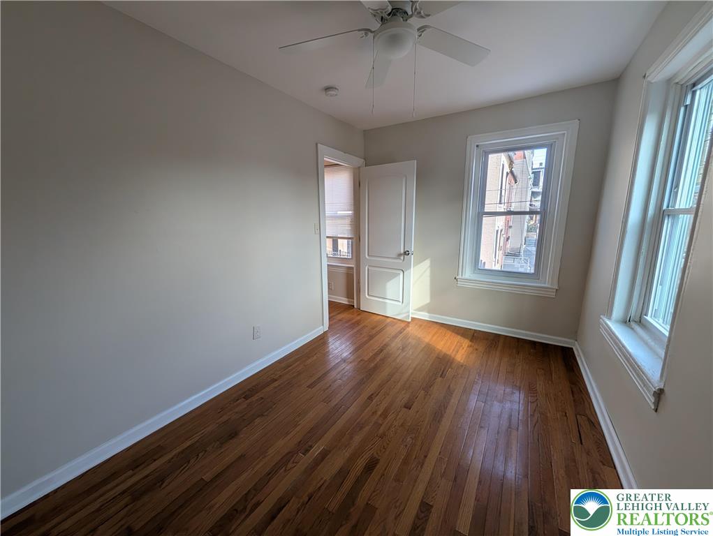 723 Chestnut Street Allentown, PA 18102 - Photo 21 of 25 a view of an empty room with a window and wooden floor